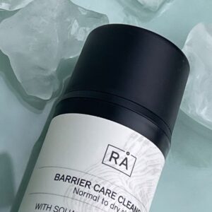 Cleansing cream with turquoise ice background