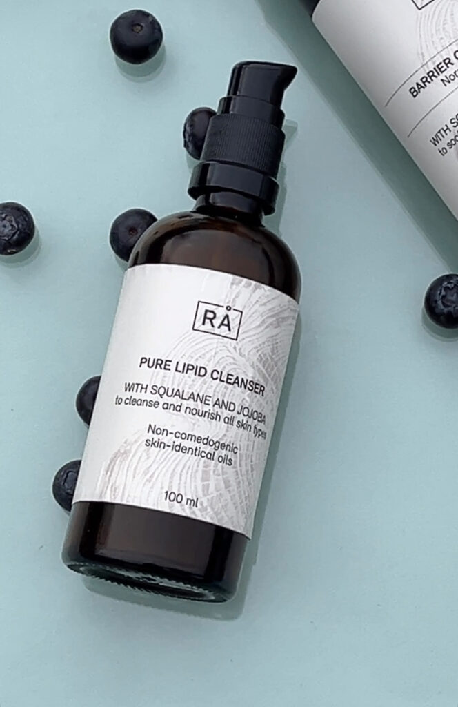 facial cleanser with turquoise background with blueberries