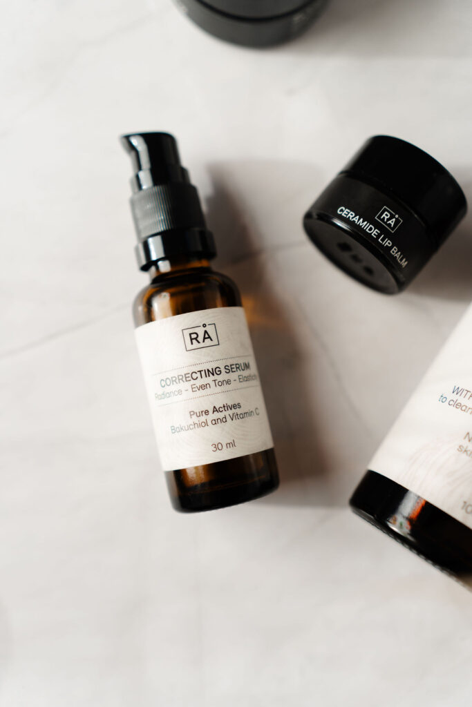 raw correcting serum lies on a light background together with ceramide lip balm and cleanser