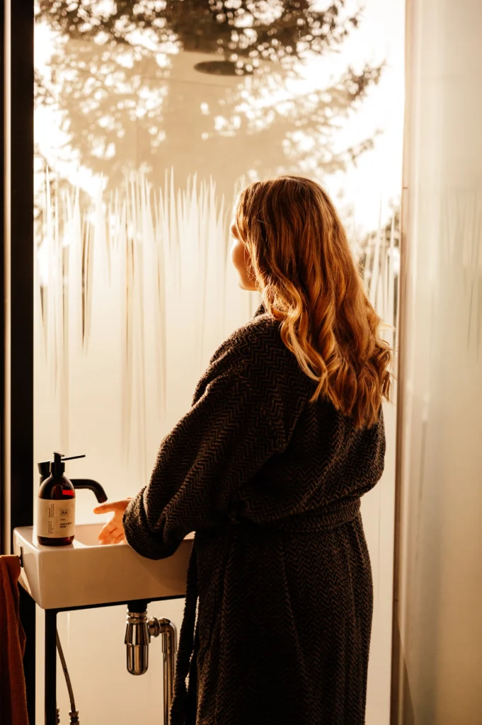 Woman washing herself with soapy hand soap