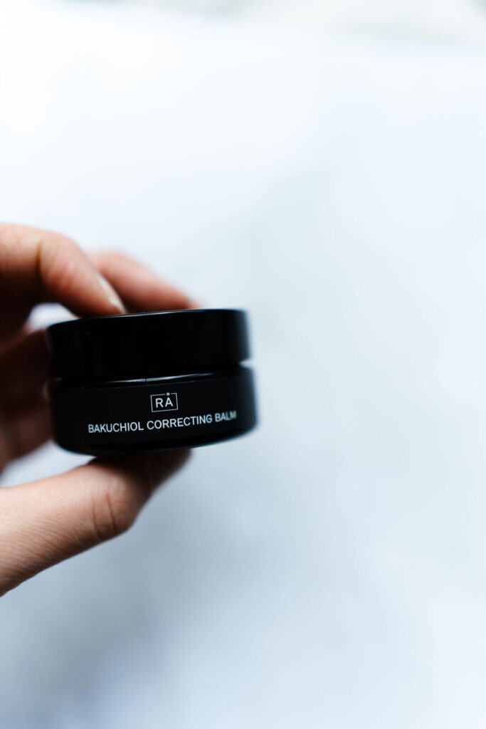 Bakuchiol correcting balm is held in the hand