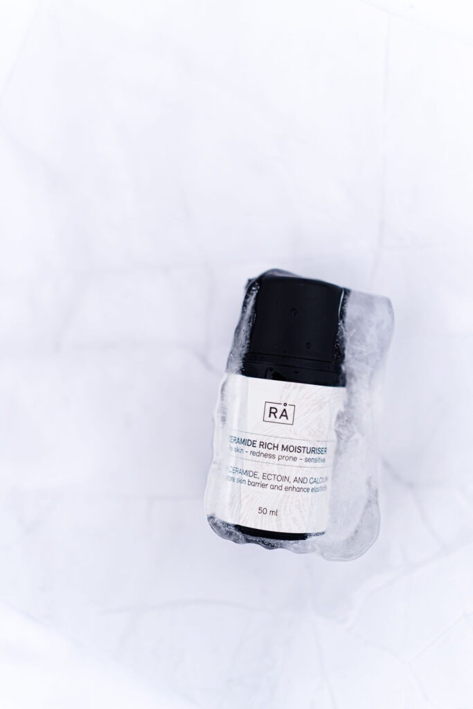 ceramide rich moisturiser inside ice cube with light background